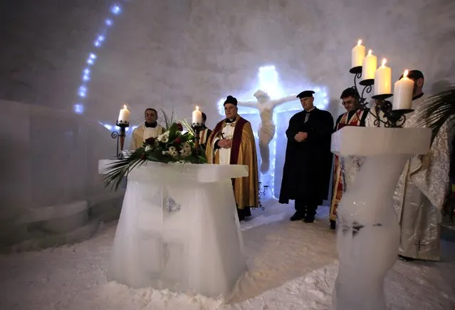 A group of priests of various congregations hold an inaugural mass for a church made entirely from ice at Balea Lac resort in the Fagaras mountains January 29, 2015. (Photo by Radu Sigheti/Reuters)