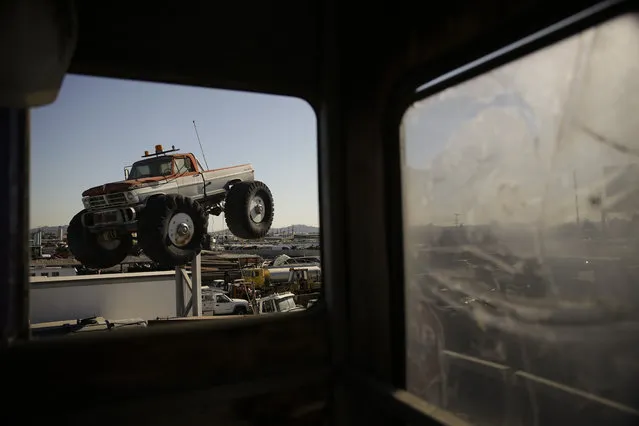 In this Wednesday, November 11, 2015 photo, junks cars are seen through the window of a watch shack at Aadlen Brothers Auto Wrecking, also known as U Pick Parts, in the Sun Valley section of Los Angeles. (Photo by Jae C. Hong/AP Photo)