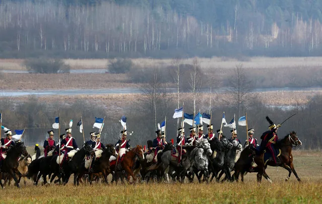 People dressed in the historic uniforms of the French army take part in a re-enactment of the 1812 Battle of Berezina, to mark the 204th anniversary of the battle, near the village of Bryli, Belarus, November 27, 2016. (Photo by Vasily Fedosenko/Reuters)