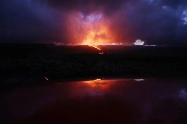 This picture taken on July 3, 2023 shows the eruption of the Piton de la Fournaise volcano on the La Reunion island. (Photo by Richard Bouhet/AFP Photo)