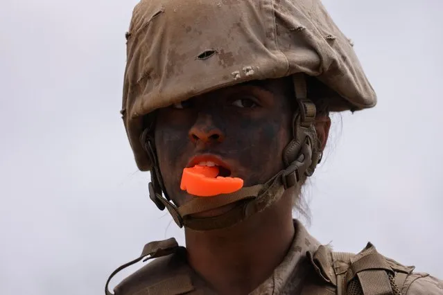 A female recruit from U.S. Marine Corps Recruit Depot San Diego participates in the grueling crucible training as their platoon break a barrier becoming the first ever women Marines trained at Camp Pendleton, California, U.S., April 21, 2021. (Photo by Mike Blake/Reuters)