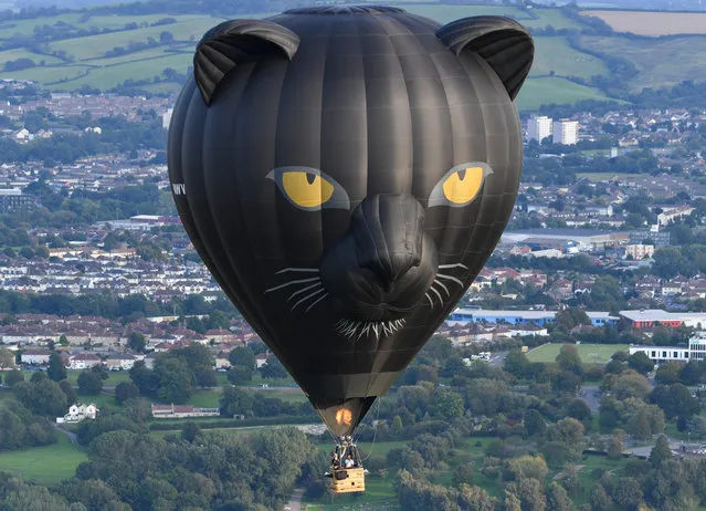 Musician Jerome Gamble plays guitar to accompany the recorded music as it is played to the city below on September 01, 2020 in Bristol, England. Created by Bristol-based artist Luke Jerram and composer Dan Jones, “Sky Orchestra – A Moment in Time” was first performed at the Bristol International Balloon Fiesta in 2003. (Photo by Finnbarr Webster/Getty Images)