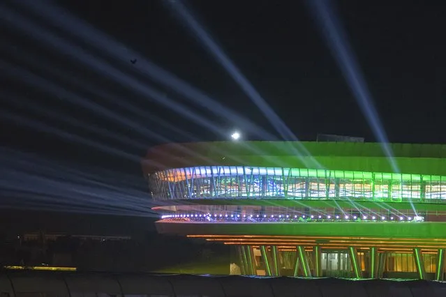 Bharat Mandapam Convention Center, the dinner venue for G20 leaders, is seen illuminated during the summit in New Delhi, India, Saturday, September 9, 2023. When the leaders of the Group of 20 arrived in host country India, they were feted by a classic Indian formula of Bollywood song and dance on the tarmac. Now as they tuck in to dinner, they are in for yet another cultural treat: dressed-up versions of a humble, earthy grain that's a staple for millions of Indians. (Photo by Dar Yasin/AP Photo)