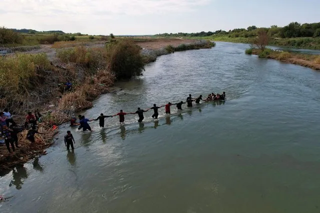 Migrants from Venezuela cross the Rio Grande into the United States in Eagle Pass, Texas, U.S., September 26, 2023. (Photo by Brian Snyder/Reuters)