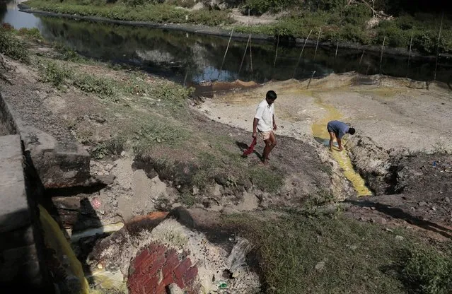 A Bangladeshi man checks the movement of industrial effluents flowing into the River Shitalakhya on the eve of World Water Day in Kachpur, near Dhaka, Bangladesh, Saturday, March 21, 2015. The U.N. warns that the world could suffer a 40 percent shortfall in water by 2030 unless countries dramatically change their use of the resource. (Photo by A. M. Ahad/AP Photo)