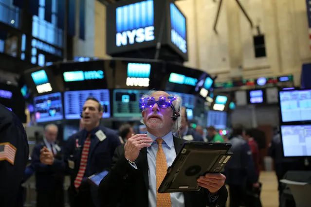 A trader wears glasses that say “2017” ahead of the new year on the floor of the New York Stock Exchange (NYSE) in Manhattan, New York City, U.S., December 30, 2016. (Photo by Stephen Yang/Reuters)