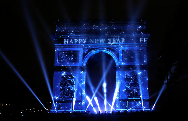 View of a light show on the city's iconic Arc de Triomphe monument during the New Year celebration in Paris, France, December 31, 2016. (Photo by Jacky Naegelen/Reuters)