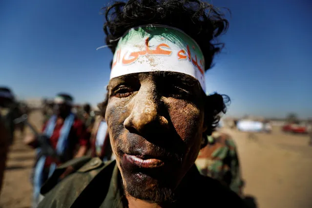 A newly recruited Houthi fighter takes part in a parade before heading to the frontline to fight against government forces, in Sanaa, Yemen January 3, 2017. The headband reads: “We are tough on infidels”. (Photo by Khaled Abdullah/Reuters)