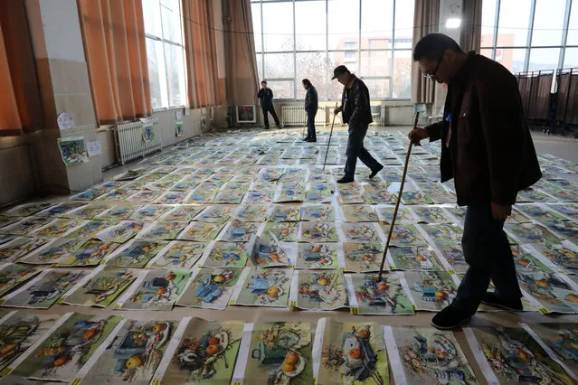 Professors inspect thousands of drawings and paintings presented by high school graduates after Shandong province's official entrance exam for students applying for fine arts major at Shandong Urban Construction Vocational College on December 19, 2018 in Jinan, Shandong Province of China. (Photo by VCG/VCG via Getty Images)