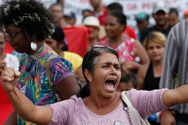 A worker shouts slogans against a proposed law that would allow companies to outsource their labor force, during a protest in Brasilia, Brazil, Tuesday, April 7, 2015. (Photo by Eraldo Peres/AP Photo)