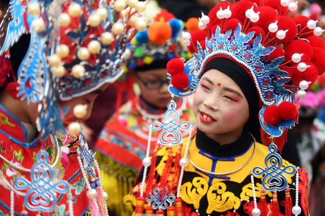 Children wearing costumes wait to perform during an event to celebrate the Chinese Lunar New Year, in Nanjing, Jiangsu province, China February 2, 2019. (Photo by Reuters/China Stringer Network)