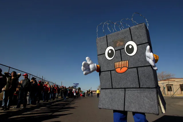 A Trump supporter dressed up as a border wall is seen as others queue to enter El Paso County Coliseum for a rally by U.S. President Donald Trump in El Paso, Texas, U.S. February 11, 2019. (Photo by Jose Luis Gonzalez/Reuters)