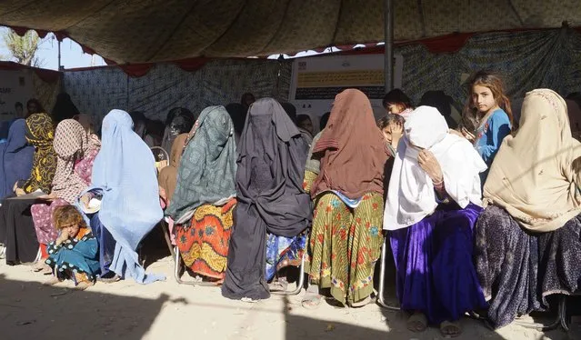 Afghan refugees wait to receive treatment at a free medical camp setup by HEADS and IRC NGOs in Dera Ismail Khan, Pakistan, 19 December 2023. About 1,7 million undocumented Afghans migrants who were in Pakistan have been affected by the 01 November 2023 deadline to leave the country, given by the Pakistani government, and as a result thousands of Afghans had to leave the country in a hurry. Pakistan's caretaker Prime Minister Kakar said his government's decision was in response to the Afghan administration's unwillingness to take action against the main Taliban group in the Asian country, the Tehreek-e-Taliban Pakistan (TTP). (Photo by Saood Rehman/EPA/EFE)