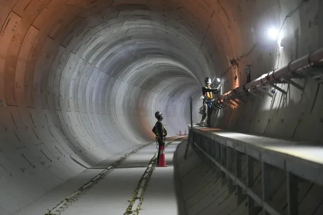 Men work inside a tunnel at a Mass Rapid Transit (MRT) construction site in Jakarta, Indonesia Thursday, January 25, 2024. The construction of the second phase of the subway line aimed at staving off crippling traffic gridlock in the megacity is scheduled to be gradually completed. (Photo by Tatan Syuflana/AP Photo)