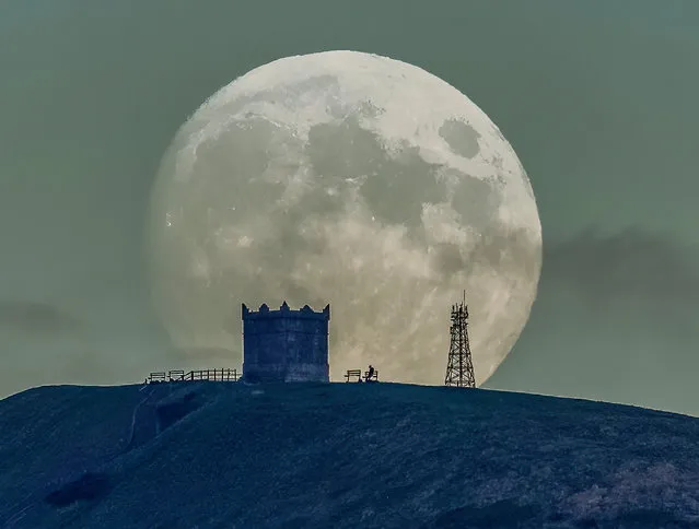 The picture dated December 6th, 2022 shows the December Cold Moon rising over Rivington Pike, Lancashire on Tuesday evening. The Native American names for the full moon in December – as reported in the Farmer's Almanac – are the Cold Moon or the Long Night Moon. The Cold Moon gets its name because December is the month when it really starts to get cold, although our coldest average temperatures are in January. (Photo by Lee Mansfield/Bav Media)