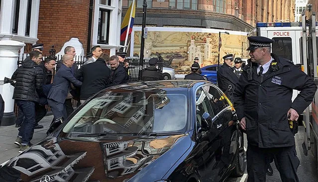 Police carry WikiLeaks founder Julian Assange from the Ecuadorian embassy in London after he was arrested by officers from the Metropolitan Police and taken into custody Thursday April 11, 2019. Police in London arrested WikiLeaks founder Assange at the Ecuadorean embassy Thursday, April 11, 2019 for failing to surrender to the court in 2012, shortly after the South American nation revoked his asylum. (Photo by @DailyDOOH/PA Wire via AP Photo)
