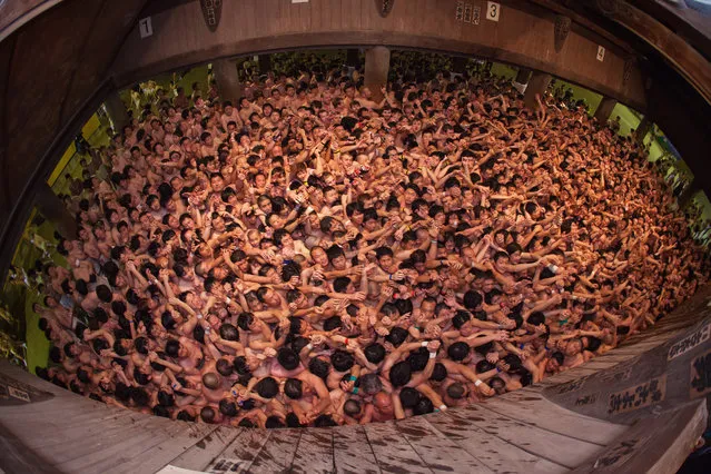 Men in loincloths participate in the Hadaka Matsuri, or Naked Festival at Saidaiji Temple on February 15, 2014 in Okayama, Japan. In this one of the most vibrant festivals in Japan, some 9,000 men battle to grab a pair of lucky sticks thrown by priests. (Photo by Trevor Williams/Getty Images)