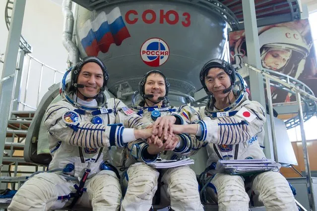 From L: US astronaut Kjell Lindgren, Russian cosmonaut Oleg Kononenko and Japanese astronaut Kimiya Yui pose for pictures as they attend a preflight training session at the Gagarin Cosmonauts' Training Centre in Star City, outside Moscow, on May 7, 2015. The crew is scheduled to blast off to the ISS from Baikonur at the end of May. (Photo by AFP Photo/Stringer)