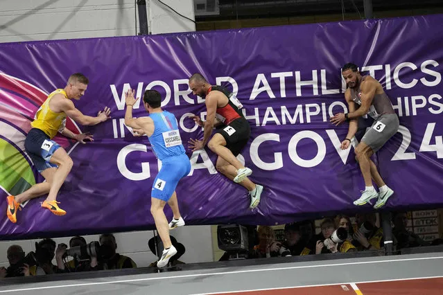 Henrik Larsson, of Sweden, Samuele Ceccarelli, of Italy, Kayhan Ozer, of Turkey, and Malachi Murray, of Canada, from left, stop against a cushion after finishing their men's 60 meters heat during the World Athletics Indoor Championships at the Emirates Arena in Glasgow, Scotland, Friday, March 1, 2024. (Phoot by Bernat Armangue/AP Photo)