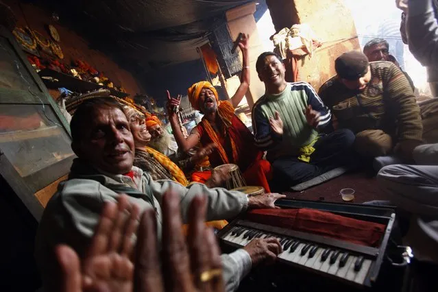 Hindu devotees sing religious songs in the courtyard of the Pashupatinath Temple in Katmandu, Nepal, Wednesday, February 26, 2014. Shivratri, a festival dedicated to the worship of Hindu God Shiva, will be celebrated Thursday. (Photo by Niranjan Shrestha/AP Photo)