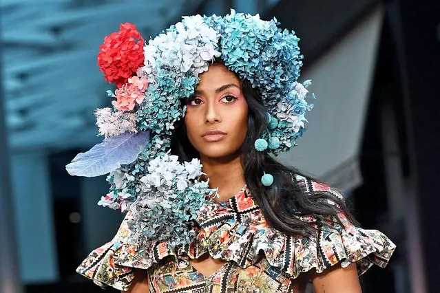 A model parades an outfit by Australian label Micky In The Van at Melbourne Fashion Week in Melbourne on November 18, 2021. As Australian labels were paraded on the runway at Melbourne Fashion Week, protests took place outside by female warehouse workers claiming they are earning up to $10 less an hour than male counterparts. (Photo by William West/AFP Photo)