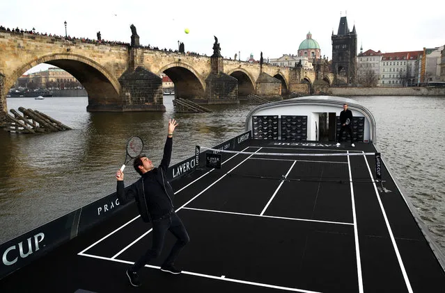 Swiss tennis player Roger Federer plays tennis with Czech tennis player Tomas Berdych on a pontoon on the Vltava river during an event to promote the Laver Cup tennis tournament on February 20, 2017 in Prague. The first Laver Cup will be held in Prague, Czech Republic, from September 22 to 24, 2017. It will be a three- day tournament with a team of the six best tennis players from Europe playing against six of their counterparts from the rest of the World. The tournament has been named in honor of Australian tennis legend Rod Laver. (Photo by Clive Brunskill/Getty Images for The Laver Cup)