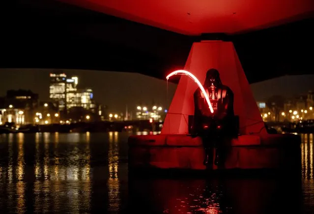 The light art project “Darth Fisher” created by Streetart Frankey is on display at the Torontobrug bridge as part of the Amsterdam Light Festival 2021, in Amsterdam, The Netherlands, 02 December 2021. The festival's light art installations can only be viewed in the early morning and late afternoon this year due to new coronavirus measures implemented by Dutch authorities amid a surge of new Covid-19 cases and concerns over the new Omicron variant. (Photo by Robin van Lonkhuijsen/EPA/EFE)