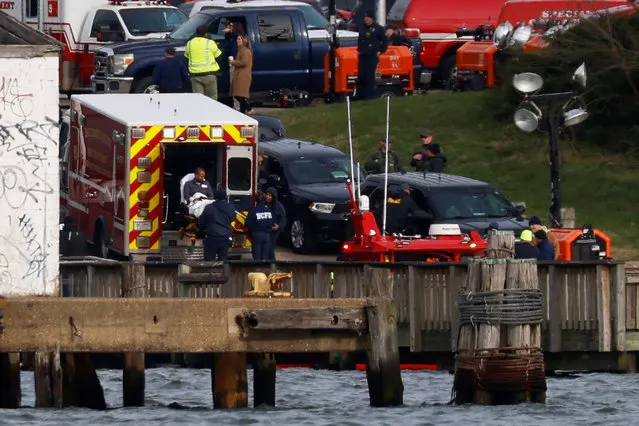 An injured sailor from Dali cargo vessel is loaded into an ambulance, after getting taken off the ship, following Francis Scott Key Bridge collapse, in Baltimore, Maryland, U.S., March 26, 2024. (Photo by Julia Nikhinson/Reuters)