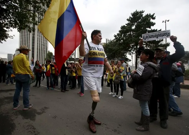 Demonstrators take part in a protest against the Revolutionary Armed Forces of Colombia (FARC) as they ask for changes to a peace agreement between FARC and President Juan Manuel Santos' government in Bogota, Colombia April 2, 2016. (Photo by John Vizcaino/Reuters)