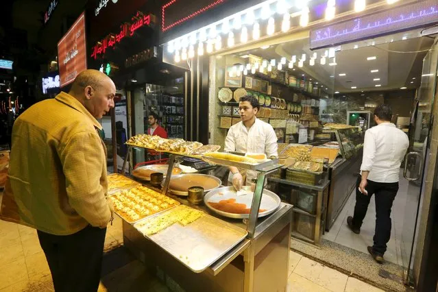 Syrians work at an eastern sweets restaurant in an area called 6 October City in Giza, Egypt, March 19, 2016. (Photo by Mohamed Abd El Ghany/Reuters)