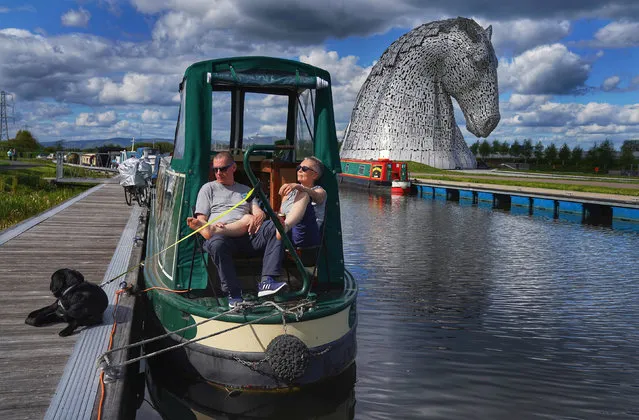 People enjoy the sun at the Kelpies, Falkirk, Scotland on May 12, 2019. (Photo by Owen Humphreys/PA Wire Press Association)