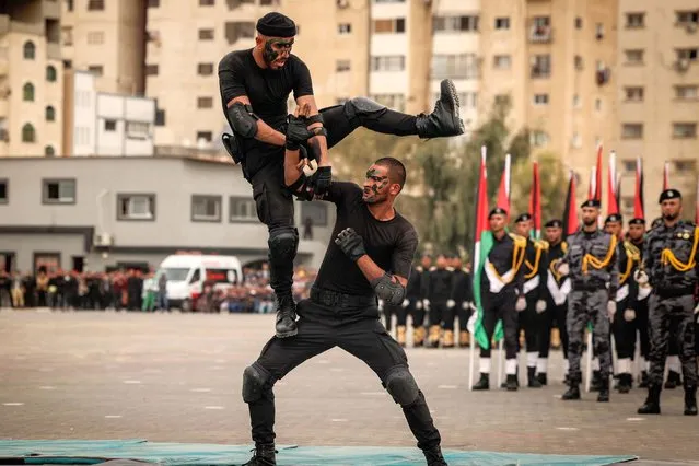 Members of the Palestinian security forces loyal to Hamas, show their skills to the public attending a graduation ceremony for police officers, in Gaza City, on December 12, 2021. (Photo by Mahmud Hams/AFP Photo)