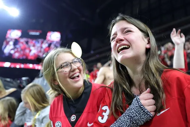 Georgia Bulldogs fans celebrate after the Georgia Bulldogs defeated the Alabama Crimson Tide 33-18 in the 2022 CFP National Championship Game at Lucas Oil Stadium on January 10, 2022 in Indianapolis, Indiana. (Photo by Carmen Mandato/Getty Images)