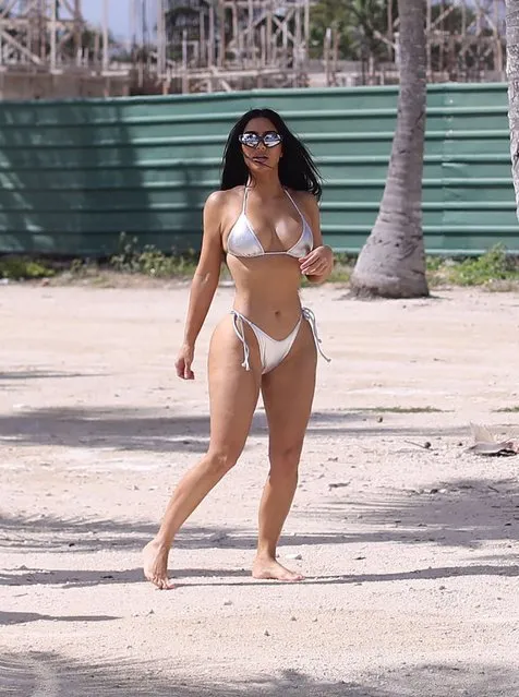 American socialite Kim Kardashian looks sensational in a silver bikini shooting for her SKIMS swimwear line with friends Natalie Halcro and Olivia Pearson in Caribbean on January 19, 2022. (Photo by The Mega Agency)