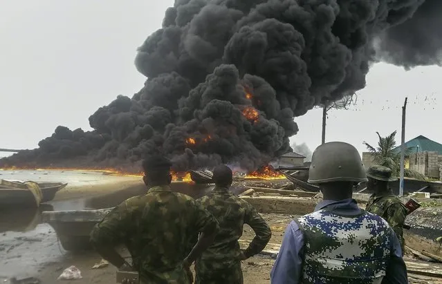 A photograph made available 29 April 2016 shows Nigerian Navy, Army, Police and Department of State Security personnel destroying about 60,000 L of illegally refined diesel stored in 91 drums at Park Community, Rivers State, Nigeria, 28 April 2016. According to the global energy consultancy group Wood Mackenzie, Africa's place as a significant producer and net exporter of oil in the world is forecast to grow to 15 percent by 2020 due to new discoveries in West Africa. Substantial growth potential exists in West Africa with 40 billion barrels of discovered but undeveloped reserves and 55 billion barrels of yet-to-find oil. (Photo by EPA/Stringer)