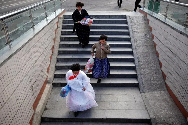 Women wearing traditional dresses walk into an underground crossing in central Pyongyang, North Korea May 4, 2016. (Photo by Damir Sagolj/Reuters)