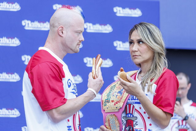 Top ranked competitive eaters, Nick Wehry (L) and Miki Sudo (R), do a “stare down”' during a weigh-in ceremony for Nathan's Famous Fourth of July International Hot Dog Eating Contest in New York, New York, 03 July 2024. Nathan's Annual Fourth of July International Hot Dog Eating Contest will take place 04 July in Coney Island, when contestants will attempt to eat as many hot dogs and buns as they can in 10 minutes. (Photo by Sarah Yenesel/EPA)