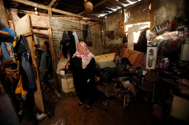 A Palestinian woman inspects her shelter that was flooded during a rainstorm, in the northern Gaza Strip February 17, 2017. (Photo by Mohammed Salem/Reuters)