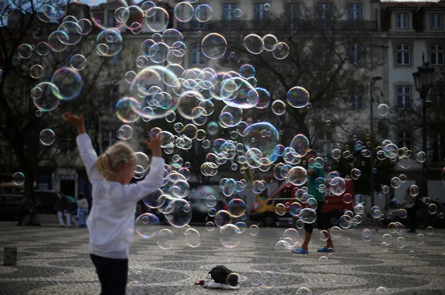 A street artist performs with soap bubbles at Rossio square in downtown Lisbon, Portugal April 28, 2017. (Photo by Rafael Marchante/Reuters)