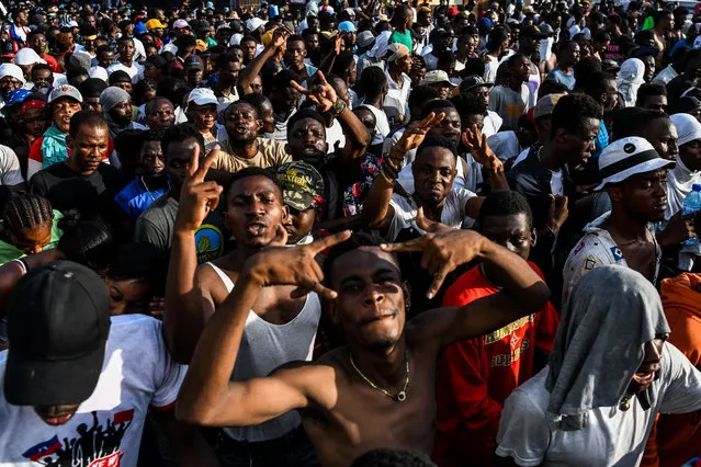 Protesters march on the street to demand the resignation of the Haitian president in Port-au-Prince, Haiti on October 13, 2019. Thousands of people demonstrated in Port-au-Prince following calls by several popular Haitian singers and artists who in turn demand the immediate resignation of the president, challenged by academics, civil society and traditional opposition parties. The Haitian opposition on October 9 rejected President Jovenel Moise's appeal for dialogue, as the country's main cities remained paralyzed after more than a month of often violent protests. (Photo by Chandan Khanna/AFP Photo)