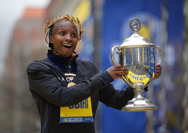 Kenya's Hellen Obiri poses with the trophy as she celebrates winning the elite women's race at the the 127th Boston Marathon in Boston, Massachusetts, U.S. on April 17, 2023. (Photo by Brian Snyder/Reuters)