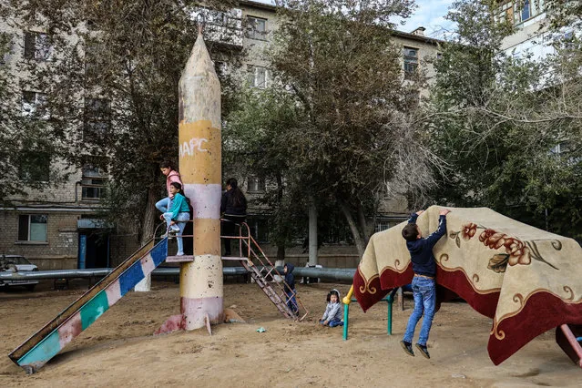 Children on a playground in the city of Baikonur, located in central Kazakhstan on September 21, 2019. The city is rented and administered by the Russian Federation and services the Baikonur Cosmodrome. (Photo by Sergei Savostyanov/TASS)