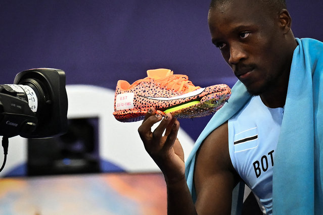 Gold medallist Botswana's Letsile Tebogo shows his shoe to the camera reading the date of birth of his late mother as he celebrates after wining the men's 200m final of the athletics event at the Paris 2024 Olympic Games at Stade de France in Saint-Denis, north of Paris, on August 8, 2024. (Photo by Ben Stansall/AFP Photo)