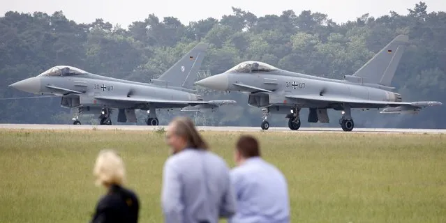 Visitors watch German Air Force Eurofighter combat aircrafts before take off at the ILA Berlin Air Show in Schoenefeld, south of Berlin, Germany, May 31, 2016. (Photo by Fabrizio Bensch/Reuters)