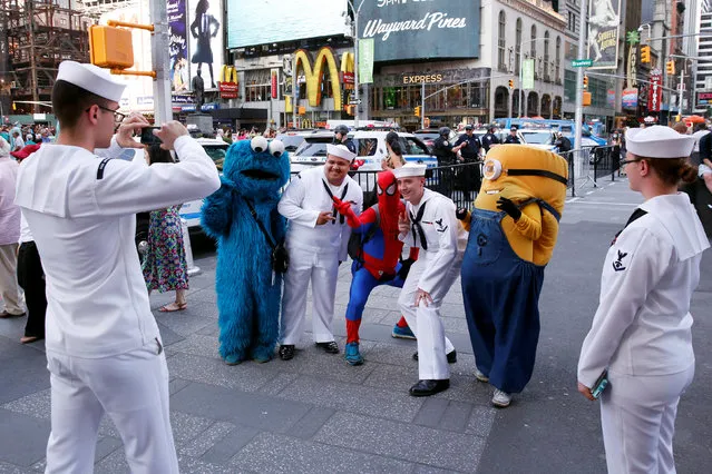 U.S. Navy sailors stop to take photographs as they walk through Times Square during Fleet Week in New York, U.S., May 25, 2016. (Photo by Lucas Jackson/Reuters)