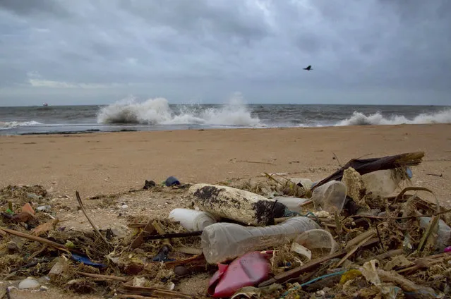 In this August 13, 2015, file photo, a plastic bottle lies among other debris washed ashore on the Indian Ocean beach in Uswetakeiyawa, north of Colombo, Sri Lanka. The 193 U.N. member nations issued an urgent call for action Friday, June 9, 2017, to reverse the decline in the health and productivity of the world's oceans - with the United States backing the action plan but rejecting its support for the Paris agreement to tackle climate change. (Photo by Gemunu Amarasinghe/AP Photo)