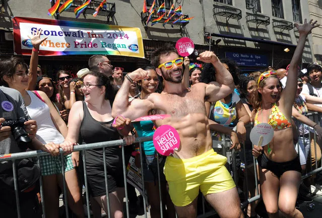 A Pride marcher with the Greater Fort Lauderdale Convention & Visitors Bureau entertains crowds at the historic Stonewall Inn during the New York Gay Pride Parade, Sunday, June 29, 2014. (Photo by Diane Bondareff/Invision for Greater Fort Lauderdale Convention & Visitors Bureau/AP Images)