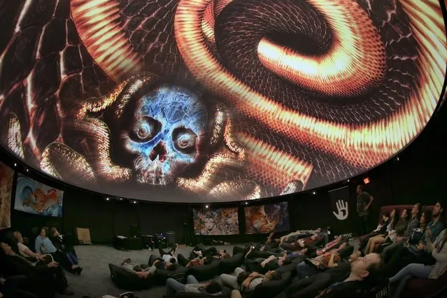 Attendees view a presentation in the Fulldome Pro display of a 360 video projection at the E3 (Electronic Entertainment Expo) in Los Angeles, California, USA, 14 June 2016. The E3 expo introduces new games and gaming devices and is an anticipated annual event among gaming enthusiasts and marketers. The event runs from 14 to 16 June 2016. (Photo by Mike Nelson/EPA)