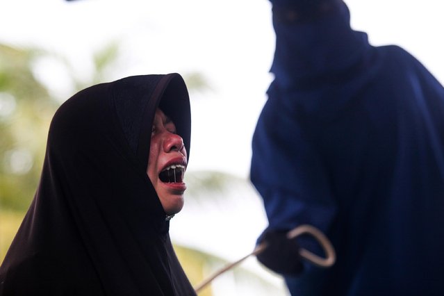 An Acehnese women is whipped in front of the public for violating sharia law in Pidie District on 14 July 2017, Aceh, Indonesia. (Photo by Oviyandi/Barcroft Images)