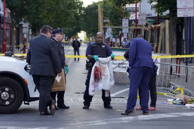 Philadelphia Police investigators work the scene of a fatal overnight shooting on South Street in Philadelphia, Sunday, June 5, 2022. (Photo by Michael Perez/AP Photo)